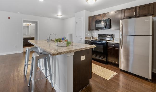 a kitchen with a marble island